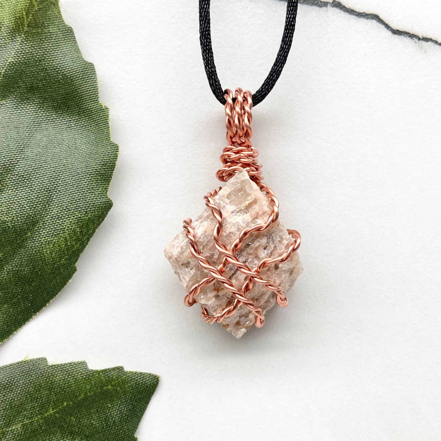 Zebradorite necklace. Raw beige stone wrapped with pure copper wire. Hangs on a black chain. Handmade metaphysical jewelry.
