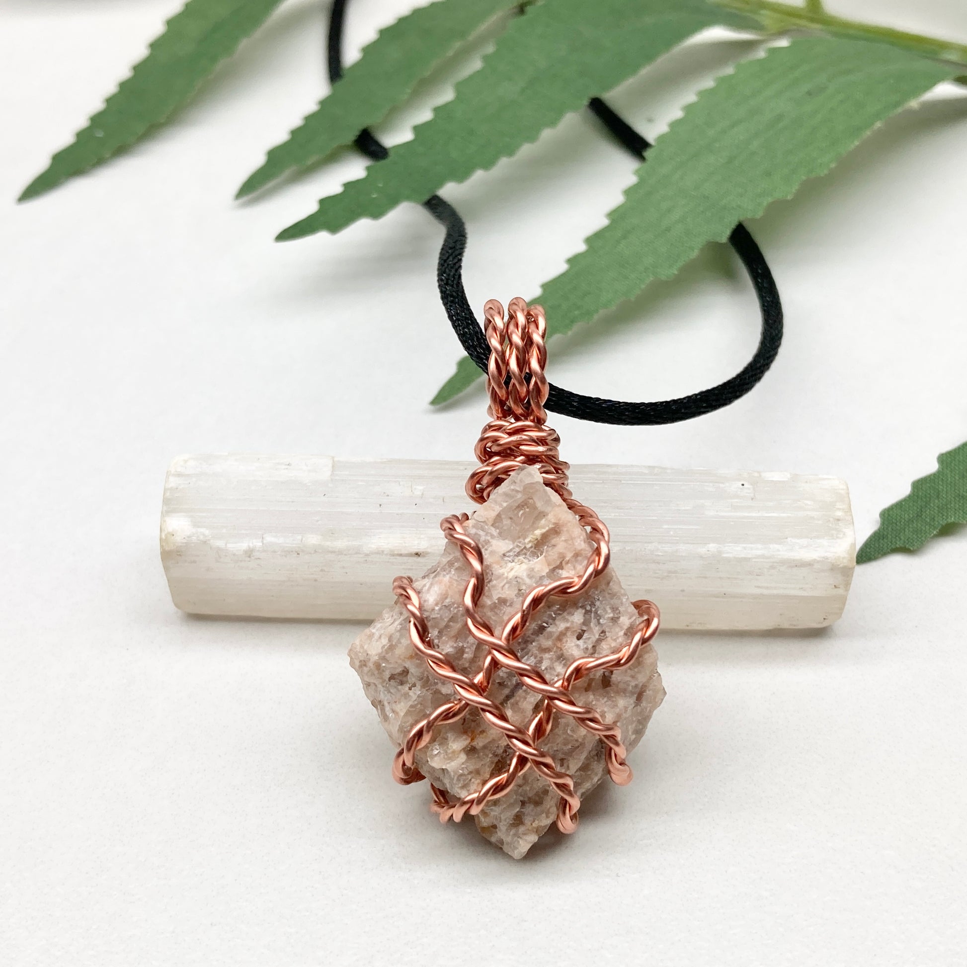 Zebradorite necklace. Raw beige stone wrapped with pure copper wire. Hangs on a black chain. Handmade metaphysical jewelry.