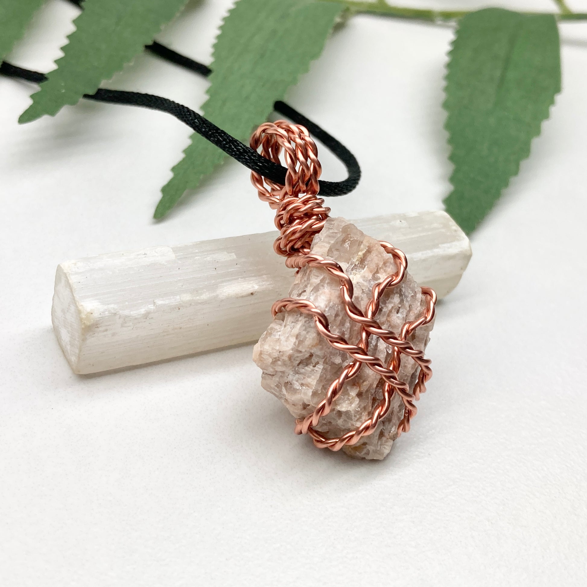 Zebradorite necklace. Raw beige stone wrapped with pure copper wire. Hangs on a black chain. Handmade metaphysical jewelry.