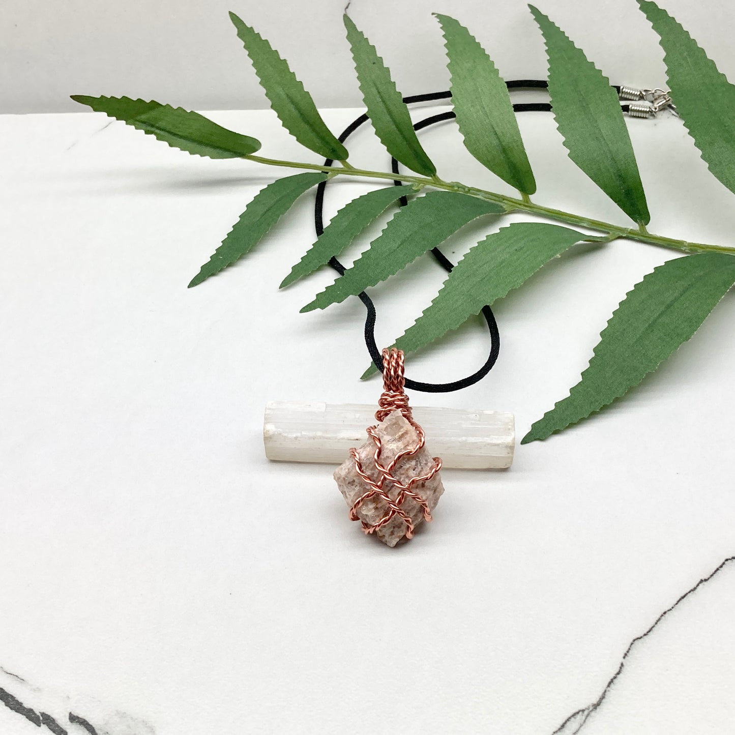 Zebradorite necklace. Raw beige stone wrapped with pure copper wire. Hangs on a black chain. Handmade metaphysical jewelry.