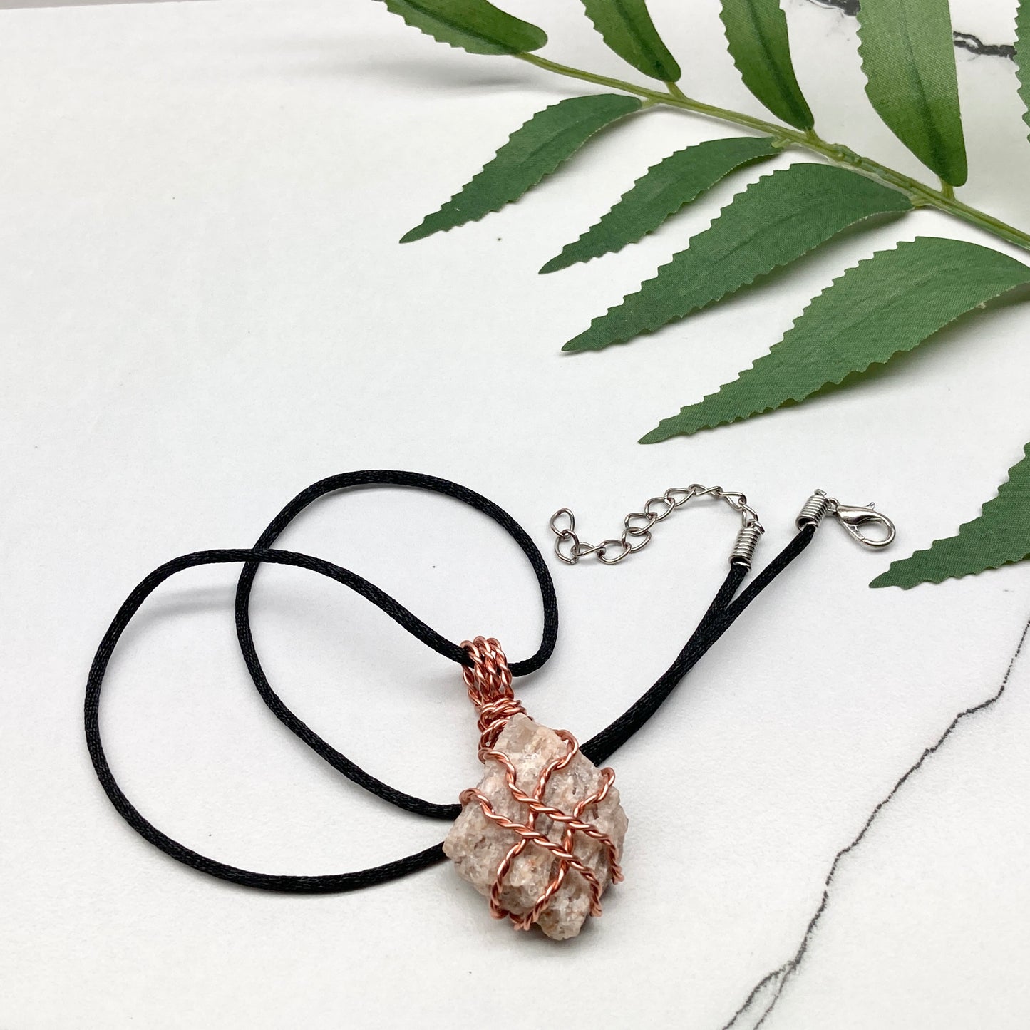 Zebradorite necklace. Raw beige stone wrapped with pure copper wire. Hangs on a black chain. Handmade metaphysical jewelry.