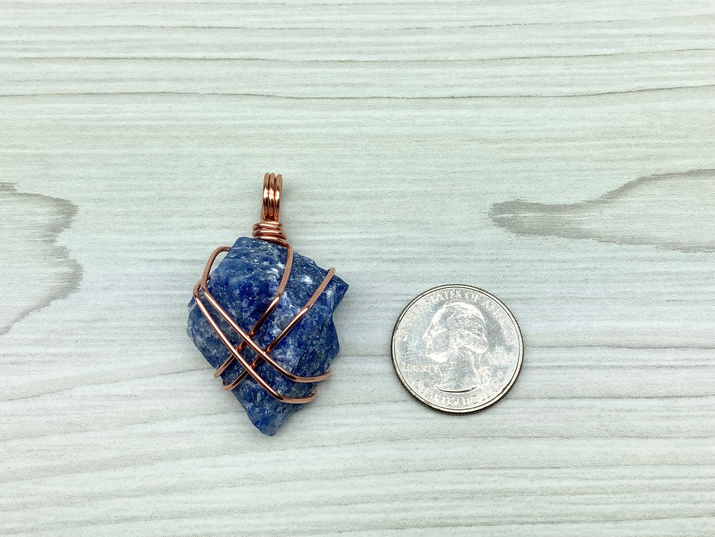 Raw Sodalite Necklace. Real Sodalite Crystal Hand Wrapped With Pure Copper Wire. Gemstone Is Blue With White In It. Comes On A Black Chain. Sagittarius Zodiac Stone Unisex Jewelry. Pendant Measures 2.3 X 1 Inches.