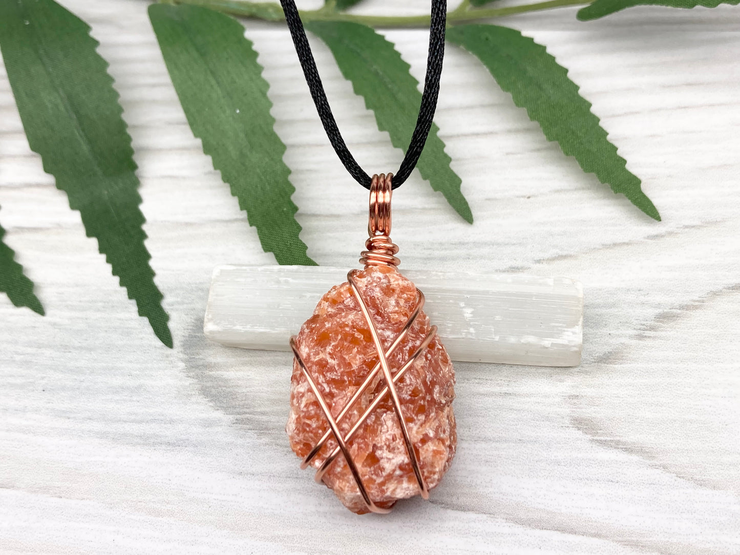 Raw Orange Calcite Necklace. Natural Orange Crystal Hand Wrapped With Copper Wire. Comes On A Black Chain. Leo Zodiac Stone Pendant. New Age Metaphysical Jewelry. Fire Element Gemstone. Free Shipping Over $35.