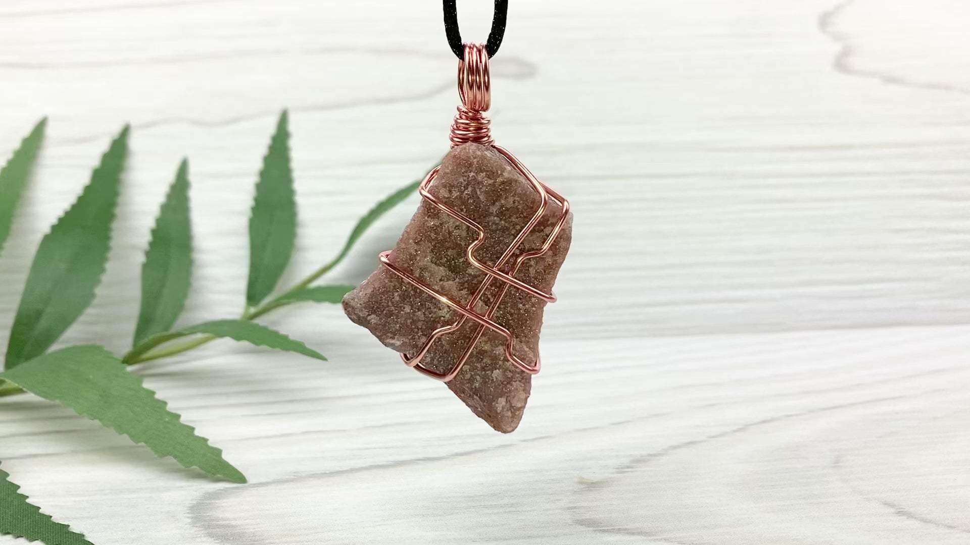 Raw Guava Quartz Necklace. Guava Quartz Crystal Wrapped With Tarnish Resistant Copper Wire. Reddish Brown Stone Pendant. Comes On A Black Chain. Aquarius Zodiac Crystal. Spiritual New Age Jewelry. Video Shows Pendant Spinning Around.